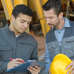 two supervisors look over safety start up sheet