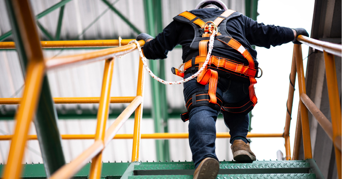 person in fall protection ppe going up stairs