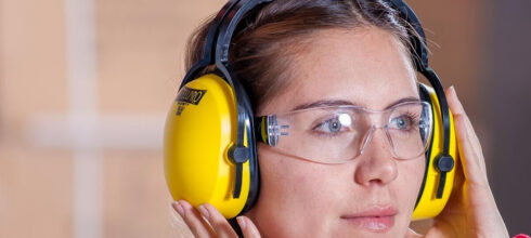 female safety employee wearing hearing protection