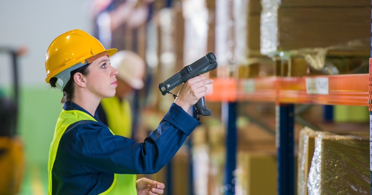 woman in industrial storeroom using vmi scanner