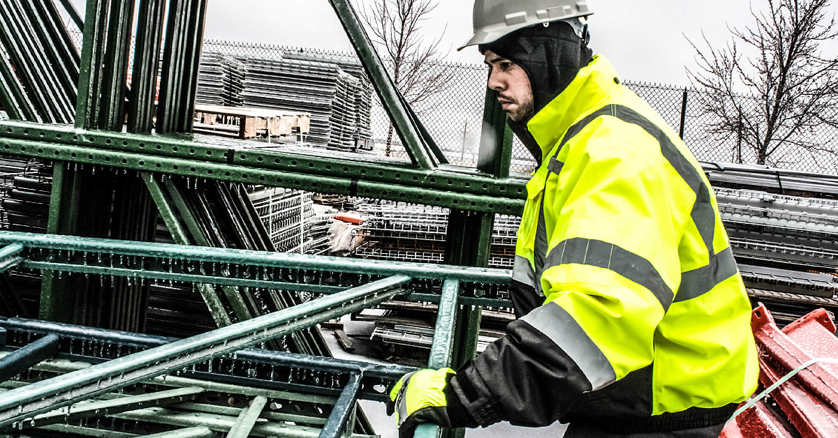 employee in the snow wearing hi-vis ppe