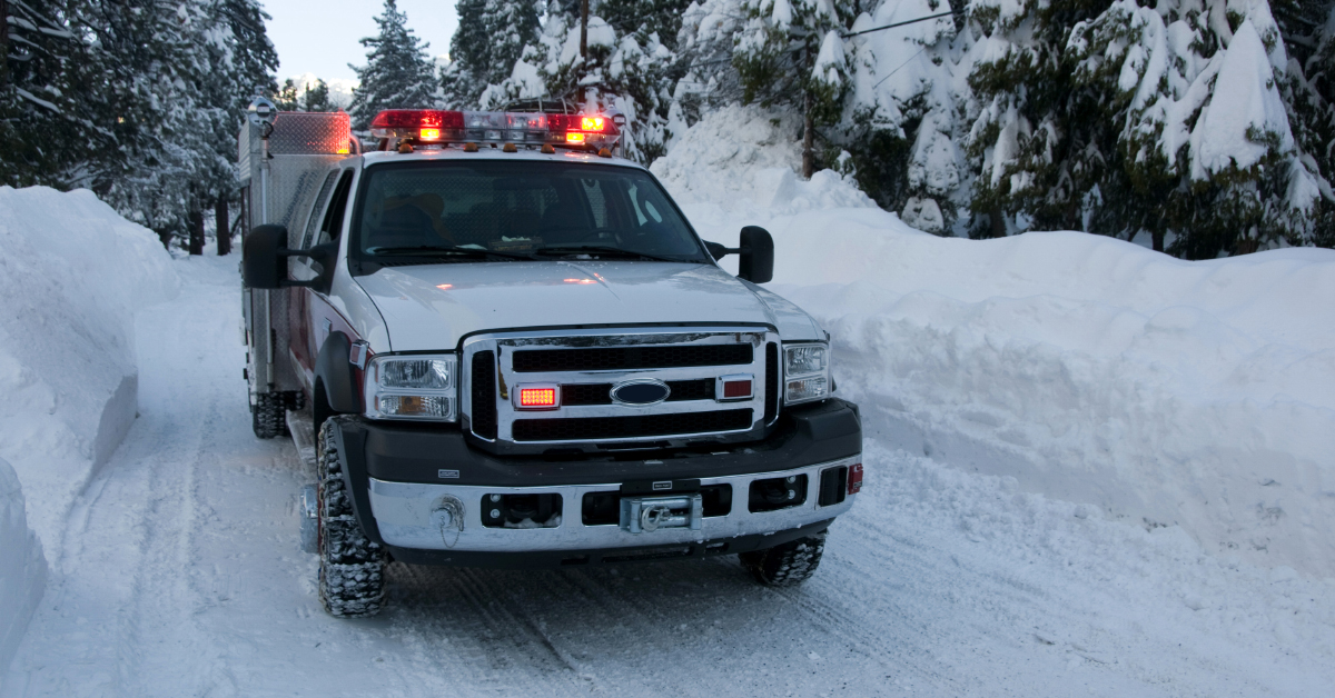 work truck driving on snowy roads in the winter