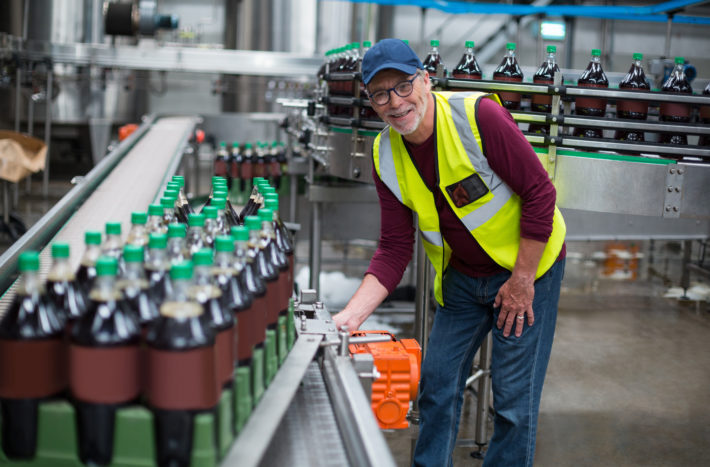 Portrait of factory worker inspecting production line