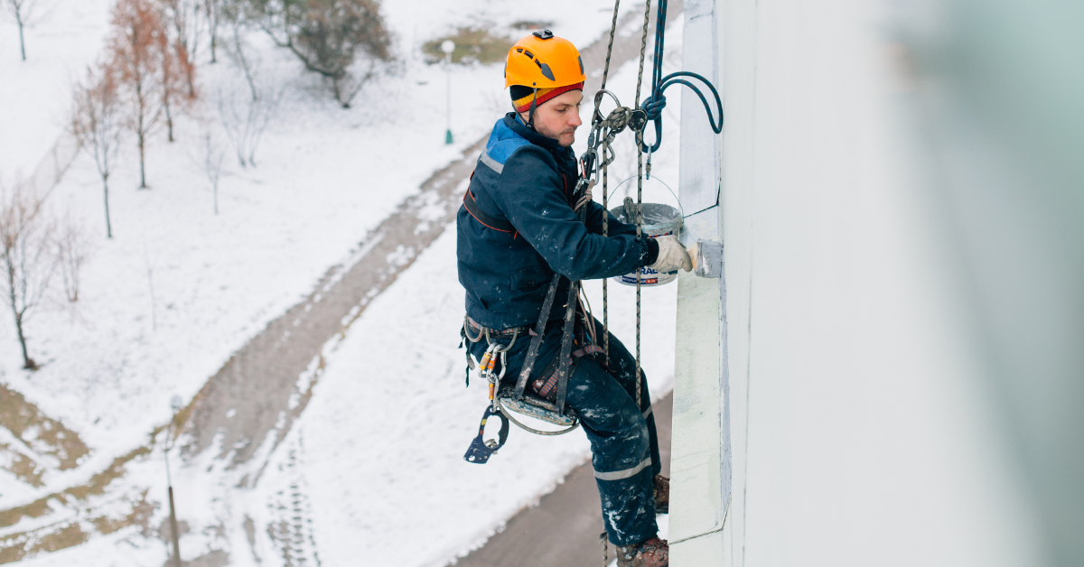 safety employee at height using fall protection in the snow