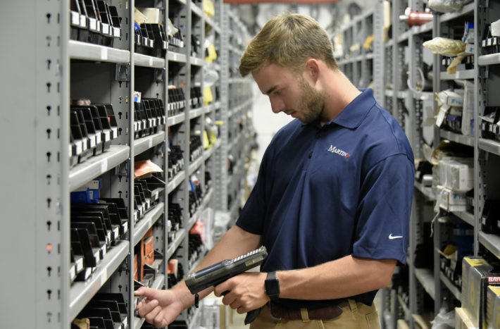 Employee scans products inventory