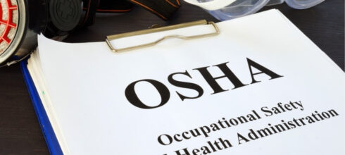OSHA regulation printout on clipboard