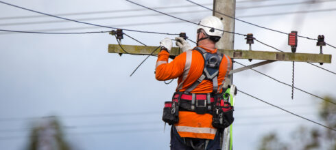 safety employee at height fixing powerline