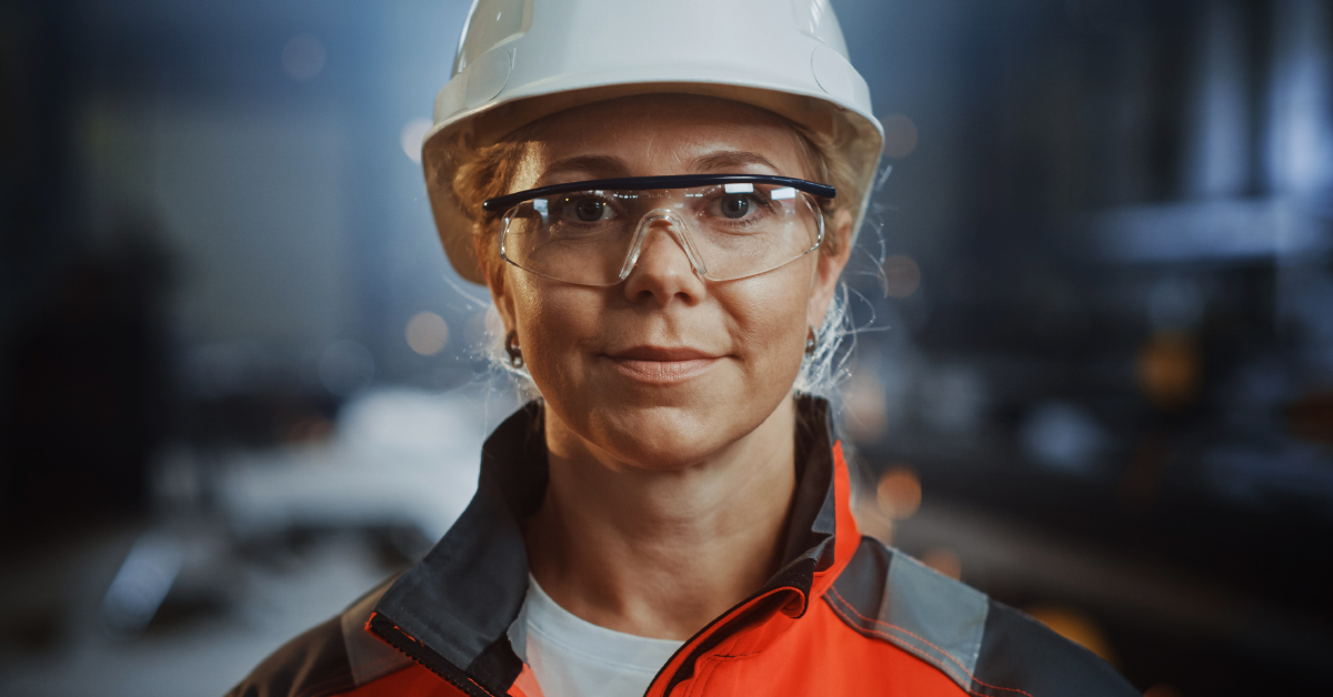 Woman in safety ppe hat and eye protection