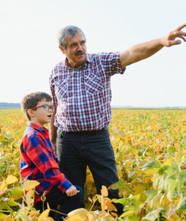 Safety employee out in a field with son