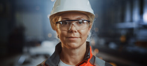 woman in safety hat, glasses and ear protection