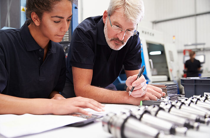 Employees figuring out a solution for metalworking