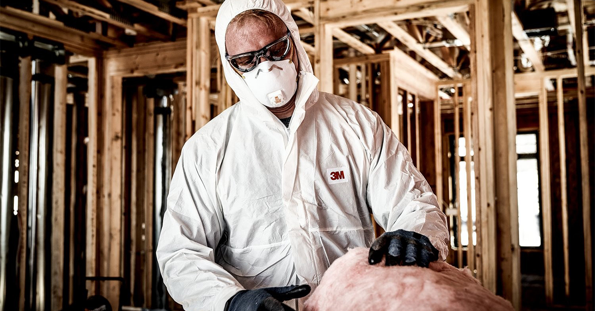 employee in full respiratory safety protection at construction site