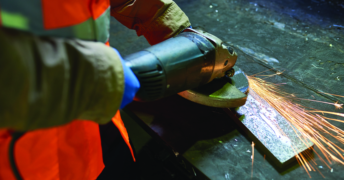 employee using industrial power tool