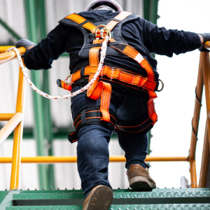 Employee climbs lift on jobsite 