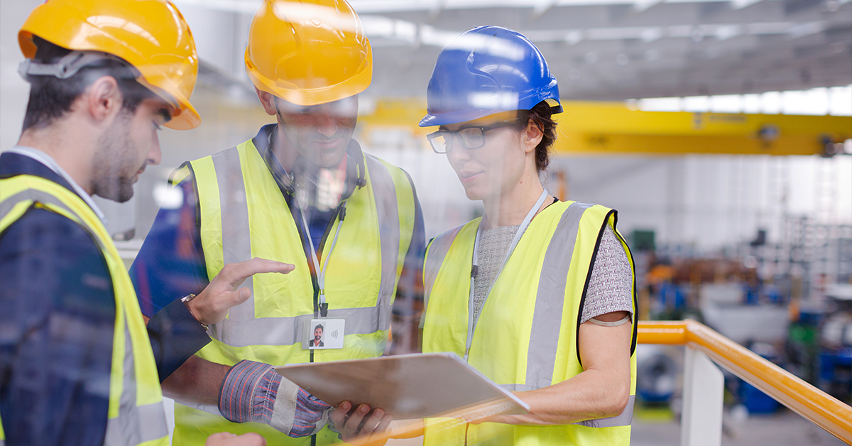 Safety employees using clipboard in PPE