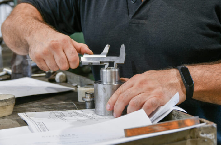 Employee gauges a metal tool