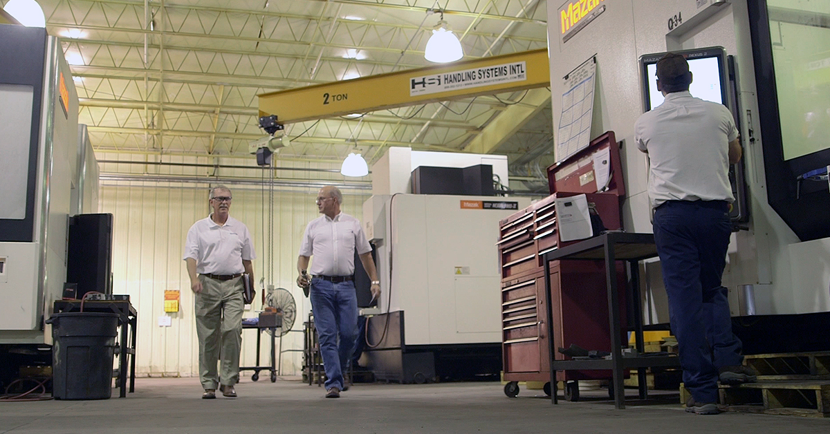 Martin sales rep walking with customer inside industrial plant