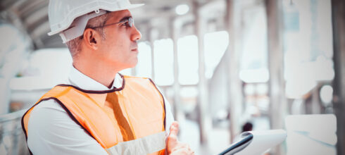 Executive safety worker in vest and hat