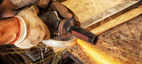 industrial grinding wheel with sparks in dark room