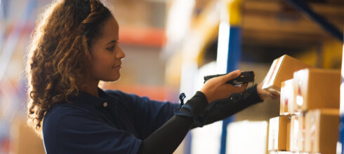 Woman in storeroom using inventory scanner