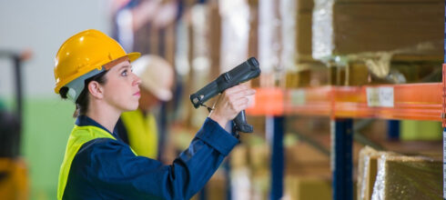 woman in industrial storeroom using vmi scanner