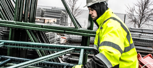 employee in the snow wearing hi-vis ppe