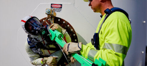 employee wearing papr respiratory protection in industrial facility