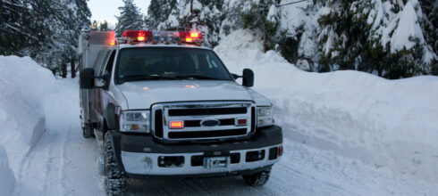 work truck driving on snowy roads in the winter