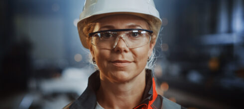 Woman in safety ppe hat and eye protection