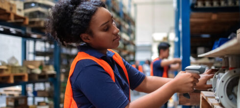 industrial warehouse female worker scanning mro product inventory