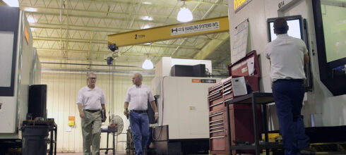 Martin sales rep walking with customer inside industrial plant