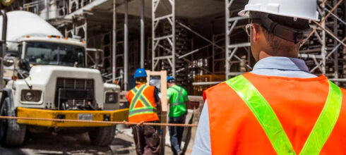 employees in safety hi-vis vest at construction site