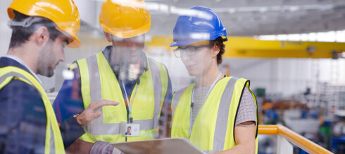 Safety employees using clipboard in PPE