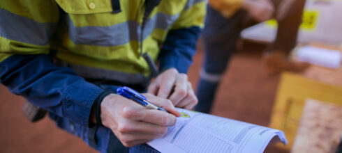 employee with clipboard accessing safety strategy