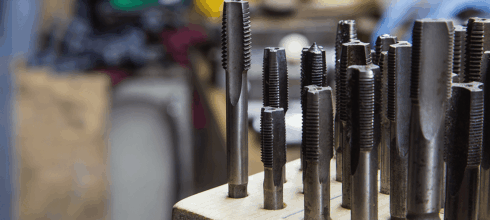 Variation of cut and roll (form taps) on display in industrial storeroom
