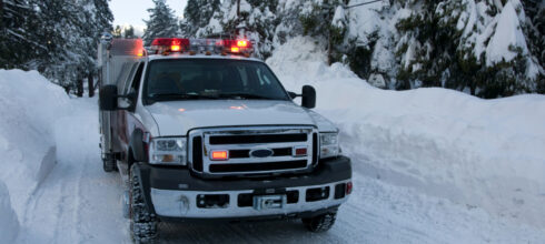 work truck driving on snowy roads in the winter